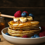 A stack of fluffy low-calorie pancakes topped with fresh berries and a drizzle of maple syrup.